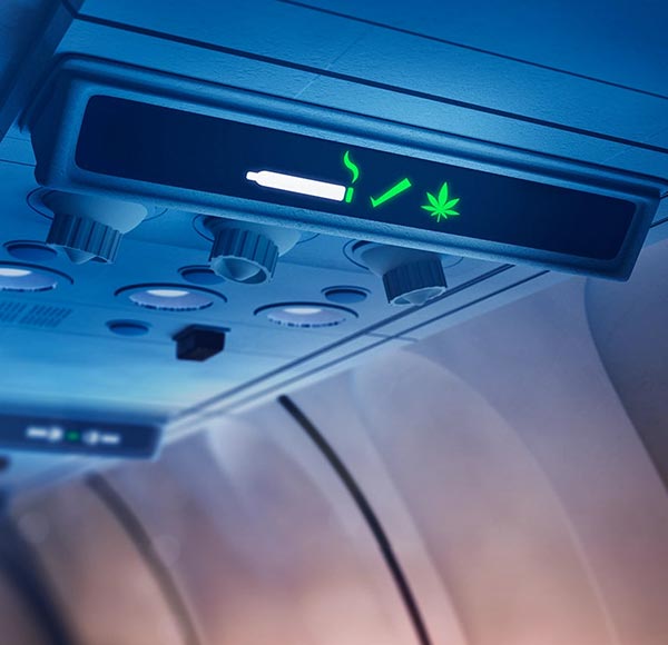 Green-lit airplane interior with marijuana decor