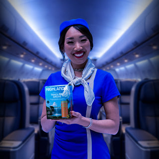 Woman holding Highlandia THC drink products on airplane